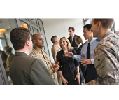 Military members in uniform speaking with business people.