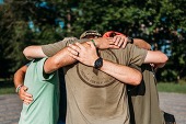 Three people hugging.